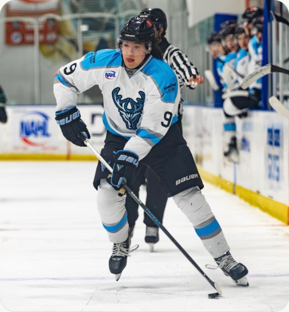 Youth hockey player driving to the net